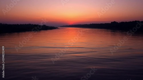 Sunset over calm water landscape.