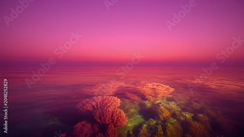 Sunset over rocky landscape formations.