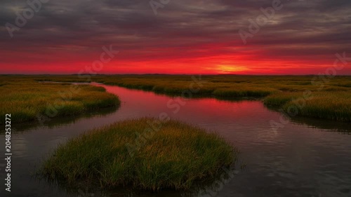 Sunset over serene water landscape.