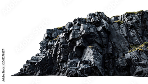 Jagged, dark rock formation, seemingly cut, displays textured surfaces. Small patches of green vegetation hint at resilience