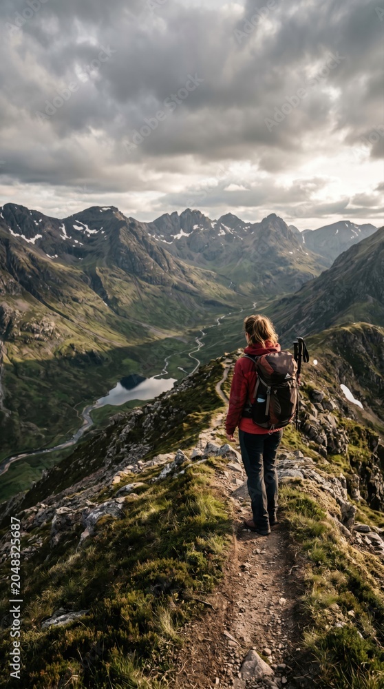 Fototapeta premium Hiking on a Mountain Ridge with Dramatic Clouds