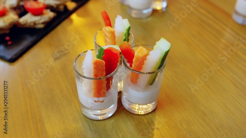 Картината върху платно Shot glasses containing creamy dip garnished with colorful vegetable sticks carr