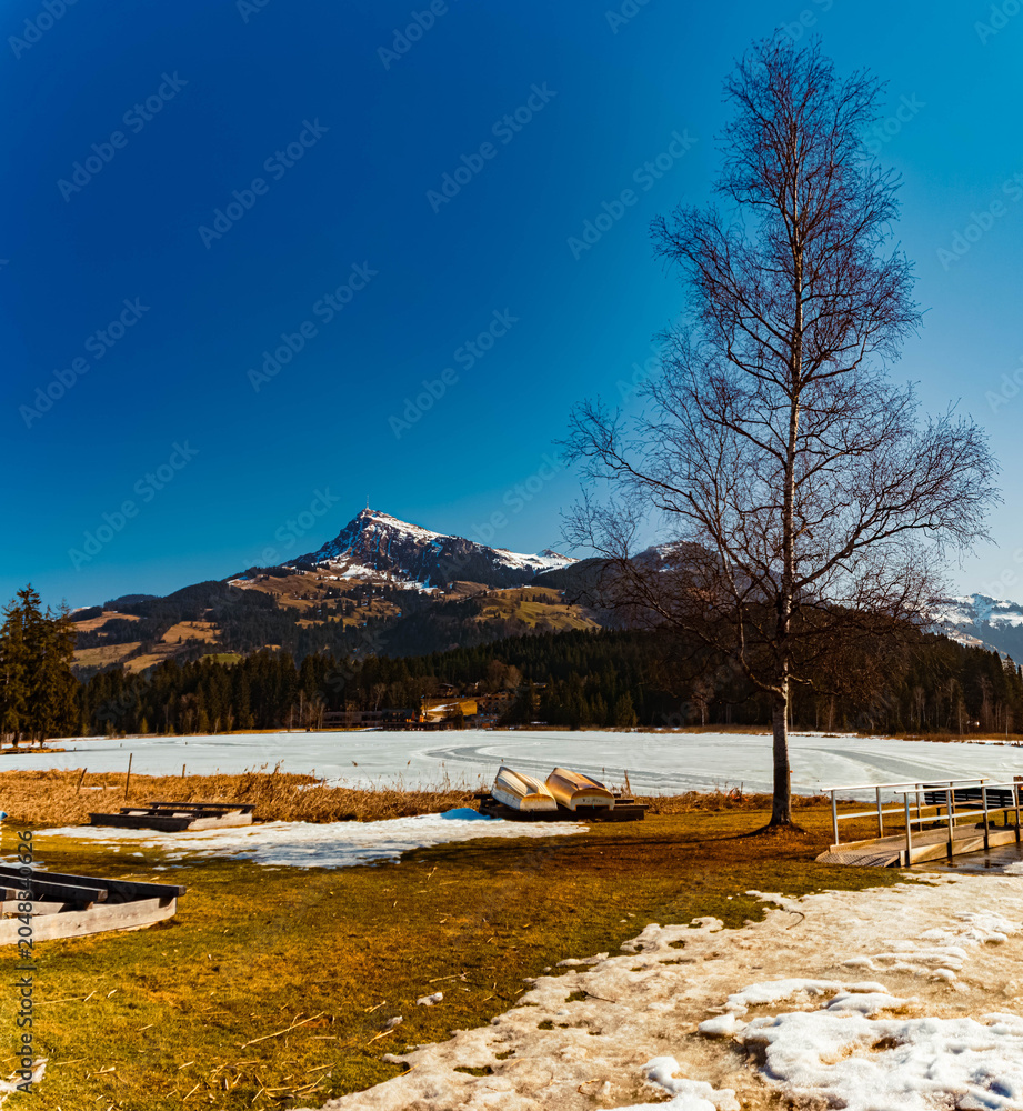 Fototapeta premium Alpine spring view with Mount Kitzbueheler Horn seen from Lake Schwarzsee, Kitzbuehel, Tyrol, Austria