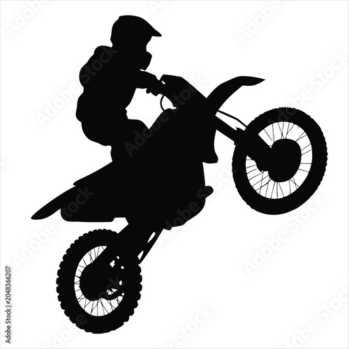 Obraz na plátně Motocross rider performing a wheelie jump silhouette on white background