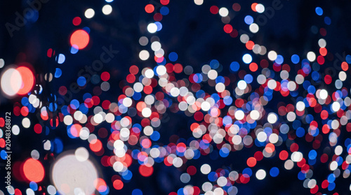 Abstract festive bokeh background with red white and blue lights.