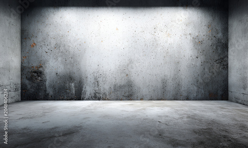 An empty, gray-toned room with concrete walls and floor. A light shines down from above, illuminating the central wall