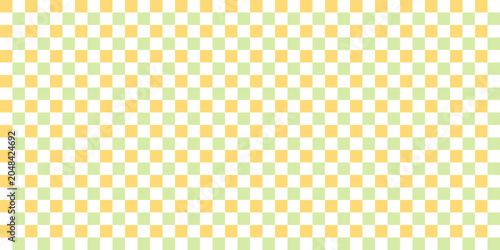 Childish checkered pattern on yellow and green. Fresh spring background. Cute baby seamless print. Pastel color