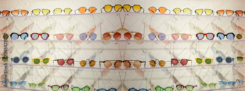 glasses with colored lenses placed on shelves