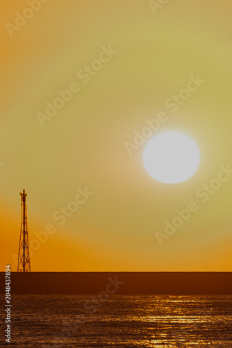 Vertical Sunrise Majesty: Pier, Sunburst, and Silhouetted Birds