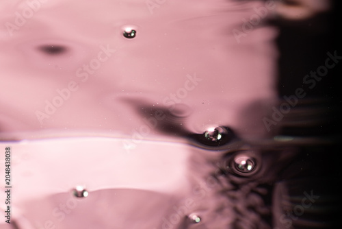 244.Pink Bubbles and Ripples on Reflective Water Surface