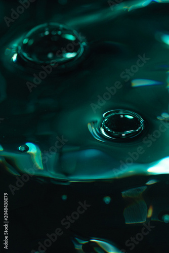 321.Dual Ripple Impact on Glossy Teal-Green Liquid