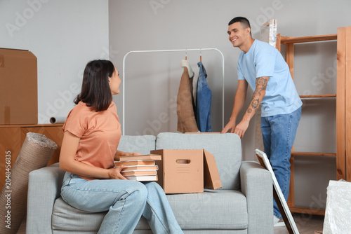 Happy young couple packing ...