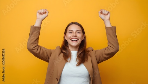 Professional Woman Celebrating Success with Arms Raised and Big Smile