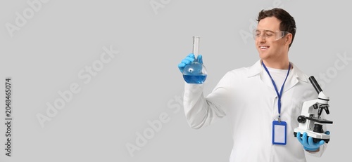 Young male scientist holdin...