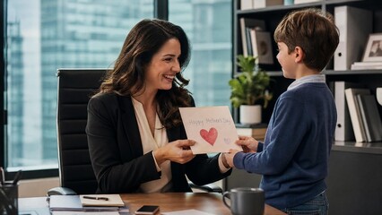 Businesswoman Receiving Mother's Day Card from Son in Office