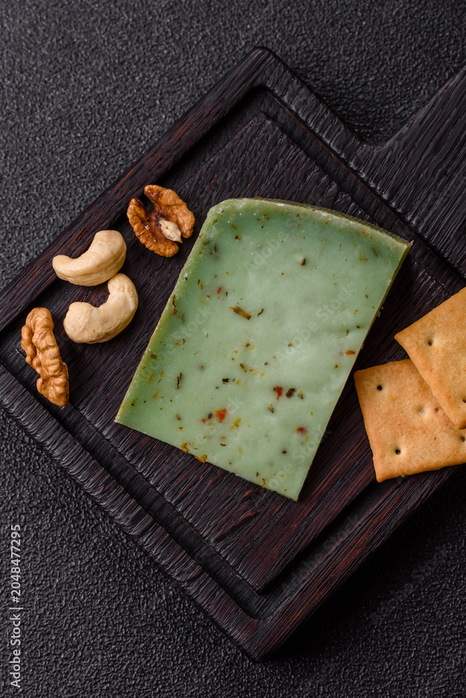 Obraz premium Hard green pesto cheese with herbs as a pasta ingredient. Green pesto cheese