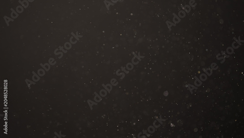 Slow motion real dust flow over dark background