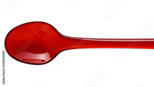 Foto Isolated vibrant red translucent glass spoon with a reflective surface and smoot
