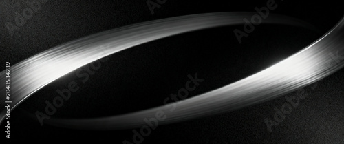 Curved metallic light trail featuring monochrome tones and subtle grain texture effects