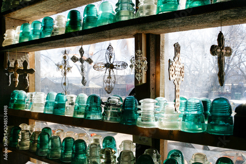 Vintage glass insulators displayed in a window