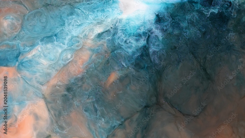 Naklejka premium Art created with alcohol ink shows abstract patterns in blue and orange during a creative session