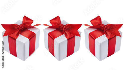 Schilderij op canvas Isolated three white gift boxes with elegant red satin bows for festive celebrat