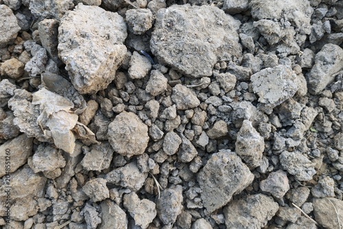 High angle view of dry clumpy clay soil and dirt rocks.