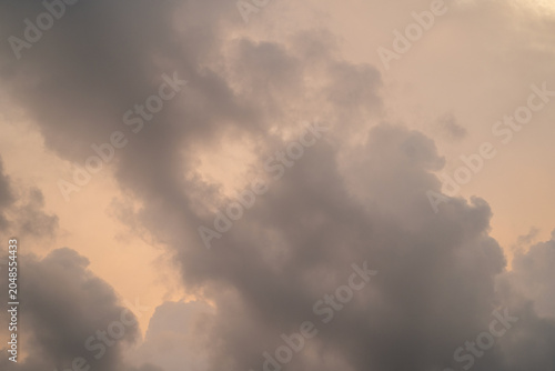 Dramatic clouds with soft hues during sunset, creating a serene atmosphere.