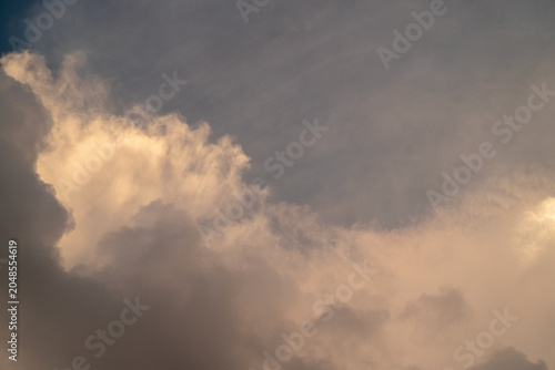 Dramatic clouds with soft hues during twilight, creating a serene atmosphere.