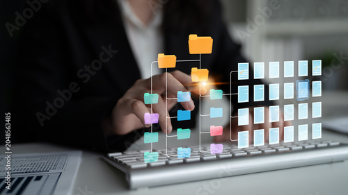 Fotografie Hands on keyboard interacting with digital file management system and folder organization interface in office environment