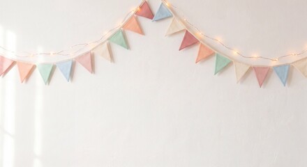 Pastel Triangular Bunting and Fairy Lights on White Wall with Copy Space