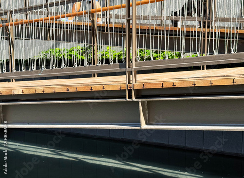 Steel structure framed elevated walkway with railing detail.