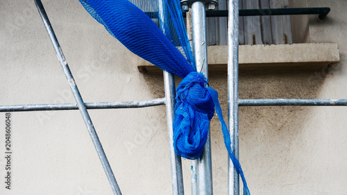 Foto Construction scaffolding with blue safety debris netting on a building site