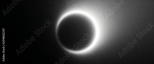 Glowing circular form on dark background with subtle grain and cinematic styling