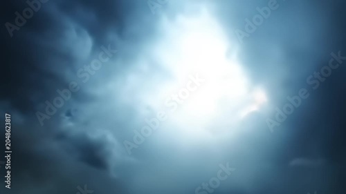 Dramatic storm clouds rolling across the sky with bright sunlight