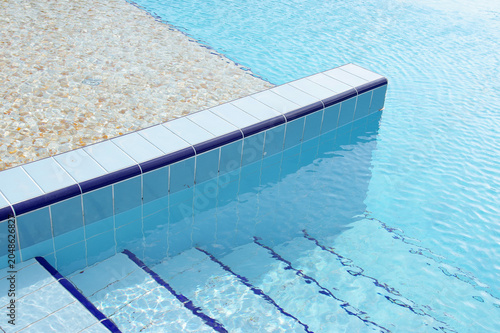 Swimming pool details in summer. Pool with clean water.