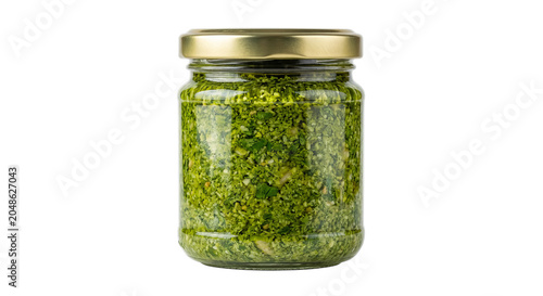 Tableau sur toile Glass jar filled with vibrant green pesto sauce, sealed with a golden lid