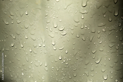 Obraz na plátne clear water droplets sticking to a flat, light gray surface