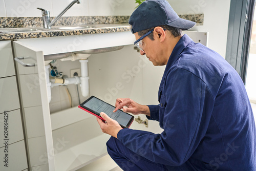 Plumber house and handyman with checklist, maintenance and service with expert. Employee contractor and repair with skills, inspection or quality control, home renovation or digital tablet