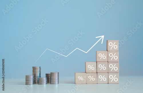 Obraz na plátně The concept of financial interest rates and mortgage interest rates is represented by wooden blocks with percentage symbols and upward-pointing arrows