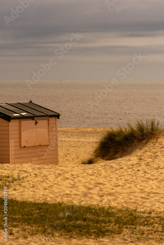 Tableau sur toile Colourful Beach Huts Overlooking the North Sea at Southwold, Suffolk Coast, Engl