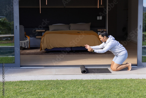 Photos Partially rolled black yoga mat is sitting on tiled patio at open bedroom thresh