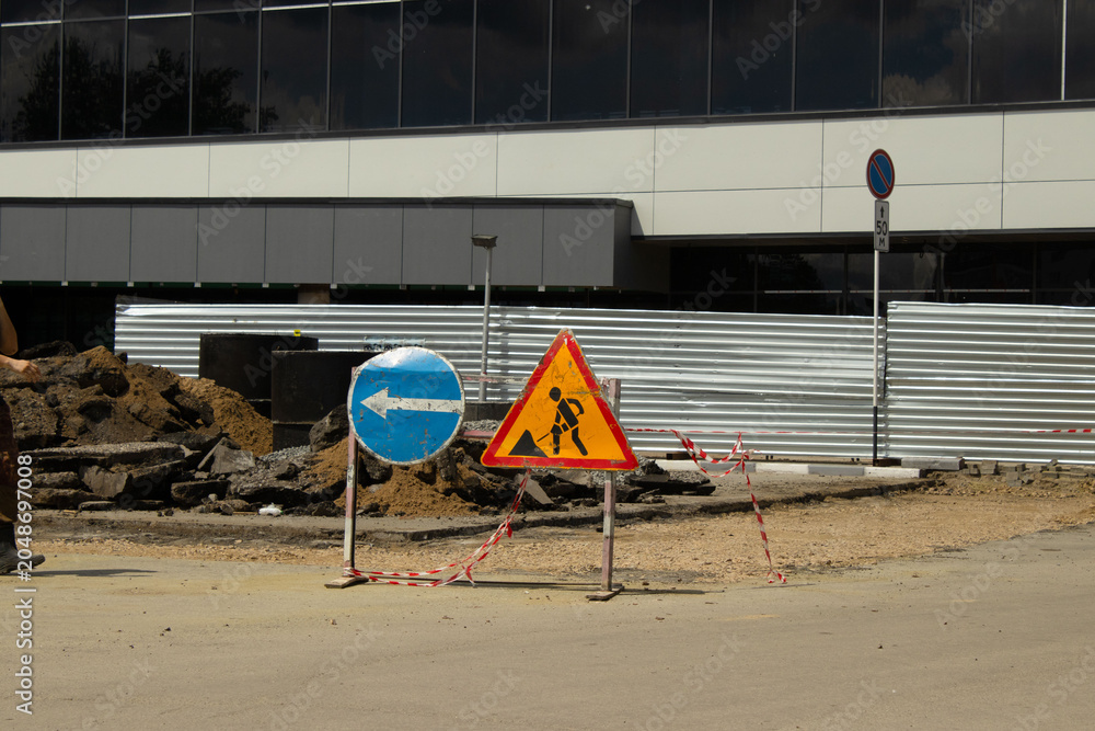 Fototapeta premium Temporary road signs at an urban street construction and repair site