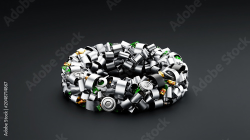 Recycling metal ring of electronic scrap on dark background, circular economy concept for recovered metal piece and battery part