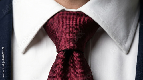 close up of man wearing shirt and tie with red necktie formal business fashion style elegance suit and collar detail