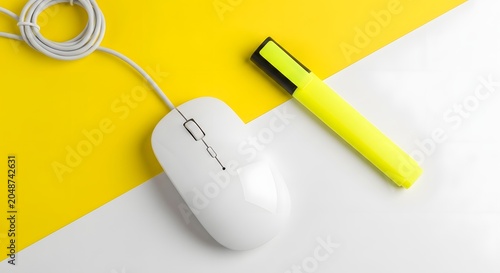 Minimalist composition of a white computer mouse and a neon yellow highlighter on a contrasting yellow and white background
