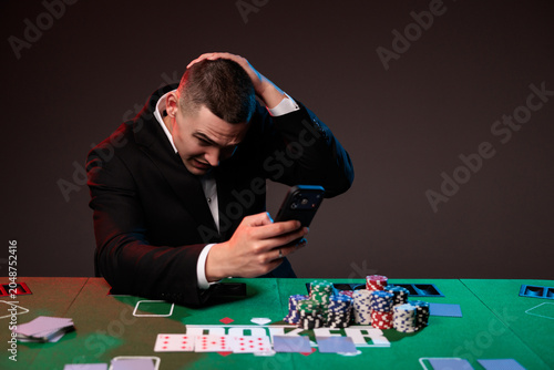 A man is depressed after losing all his bets in a casino on phone