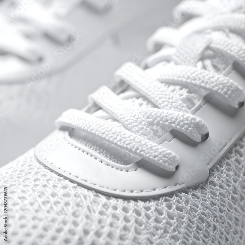 Close-up of a white knitted baby shoe.