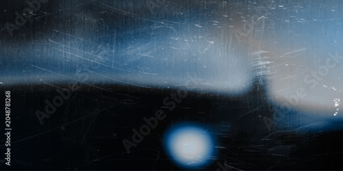Εκτύπωση καμβά Abstract moody blue and black texture with distressed scratches, glowing light spot, and a distant light source resembling a lighthouse or a blurred tower