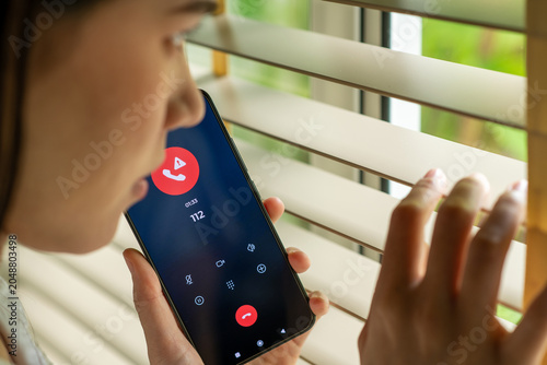 Woman calling emergency number 112 for crisis situation
